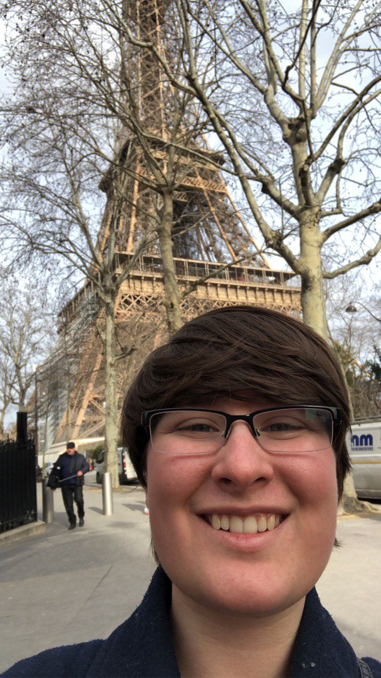 Bea Reiter smiles for a selfie in front of the Eiffel Tower